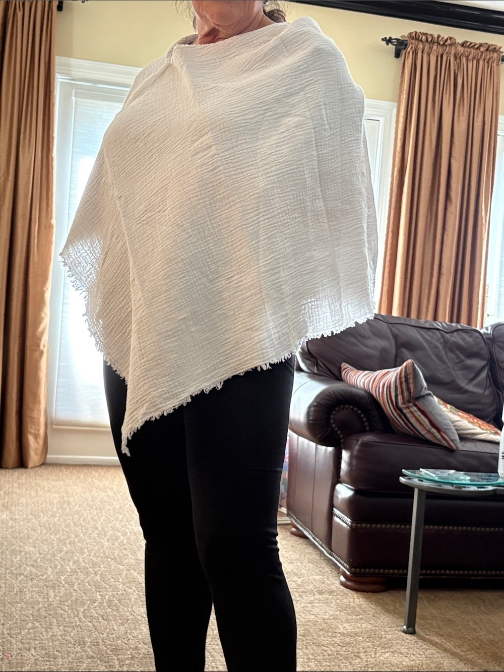 Woman’s white gauze poncho